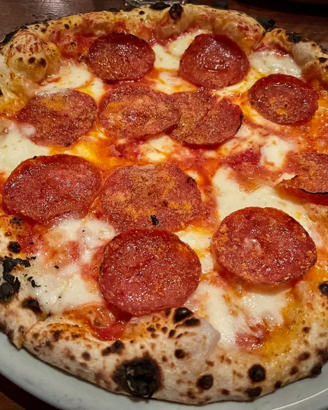 A close view of a pepperoni pizza with the sides outside the frame